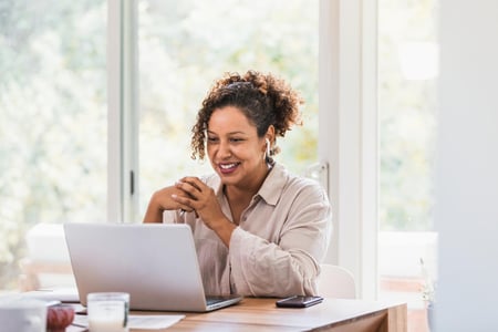 Woman sitting at laptop taking online course Woman sitting at laptop taking online course
